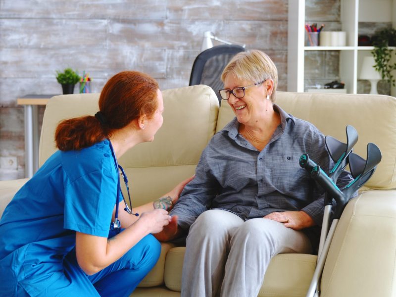 female-nurse-talking-with-old-woman-with-alzheimer-nursing-home-scaled